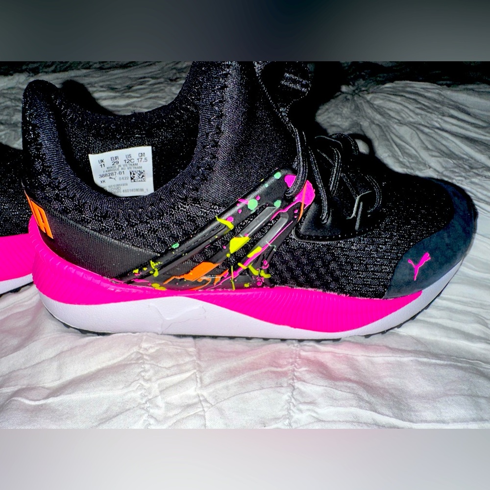 Brand new girls Puma black sneakers with pink accent. US size 12 C.
